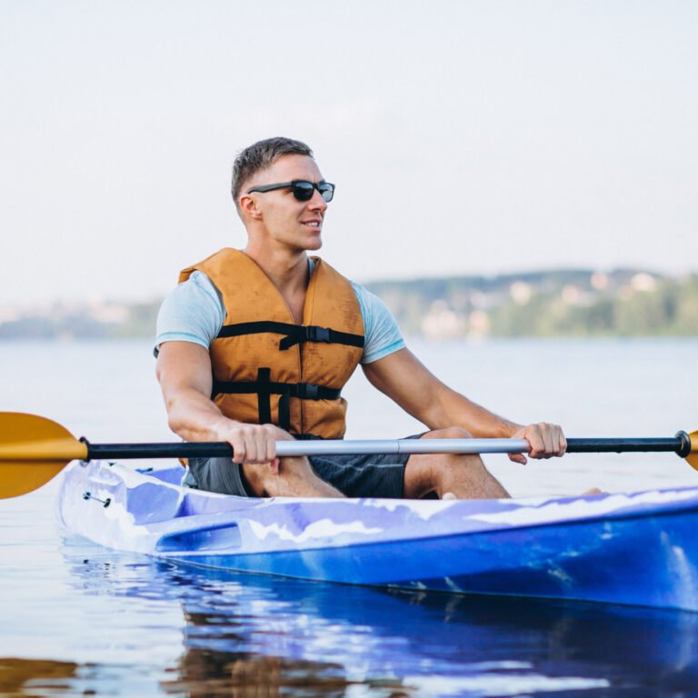 Young man kayaking on the river